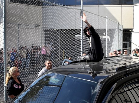 justin-bieber-climbs-on-car-and-waves-to-fans-as-he-leaves.jpg